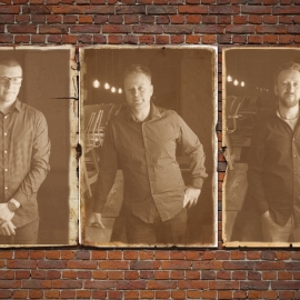 Three images of the members of Cavrn resident band Rodimus separately mounted on a brick wall