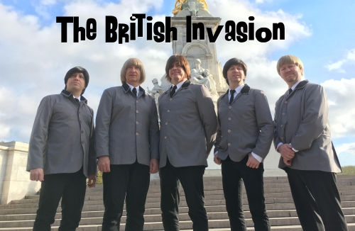 British invasion Beatles cover posing for picture on steps below monument.