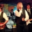 Image of British Invasion Beatles Cover band playing live on The Cavern front stage.