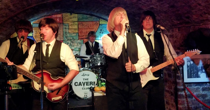 Image of British Invasion Beatles Cover band playing live on The Cavern front stage.