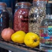 The Cavern Club Gin bottle on shelf with gin ingredients