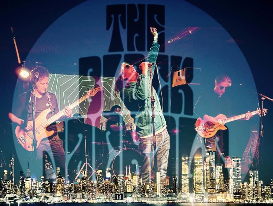 The Black Jackals performing live on stage with bold logo and city skyline graphic overlay.