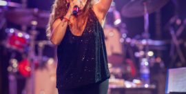 Sandra Mihanovich performing live on stage, singing passionately with microphone, at a concert ahead of her 2025 show at The Cavern Club in Liverpool.