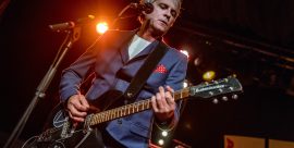 Russell Hastings performing live on stage with a Rickenbacker guitar at The Cavern Club