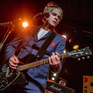 Russell Hastings performing live on stage with a Rickenbacker guitar at The Cavern Club
