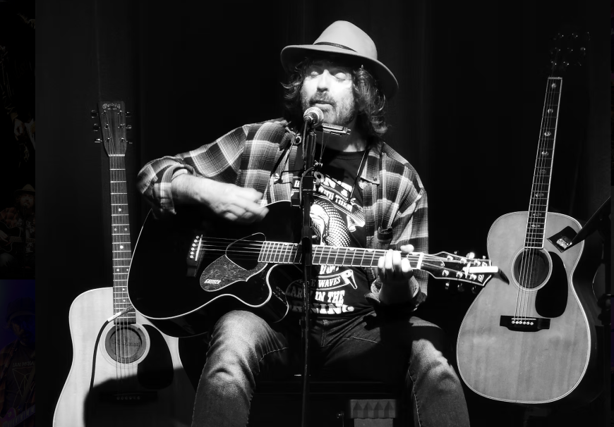 Ian McNabb performing live with acoustic guitar at the Cavern Club Liverpool