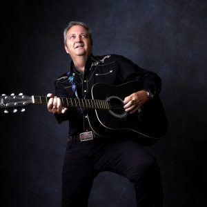 Billy Fury tribute artist performing live with acoustic guitar at the Cavern Club Liverpool