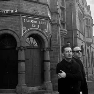 These Smiths tribute band outside Salford Lads Club in Manchester recreating iconic The Smiths imagery